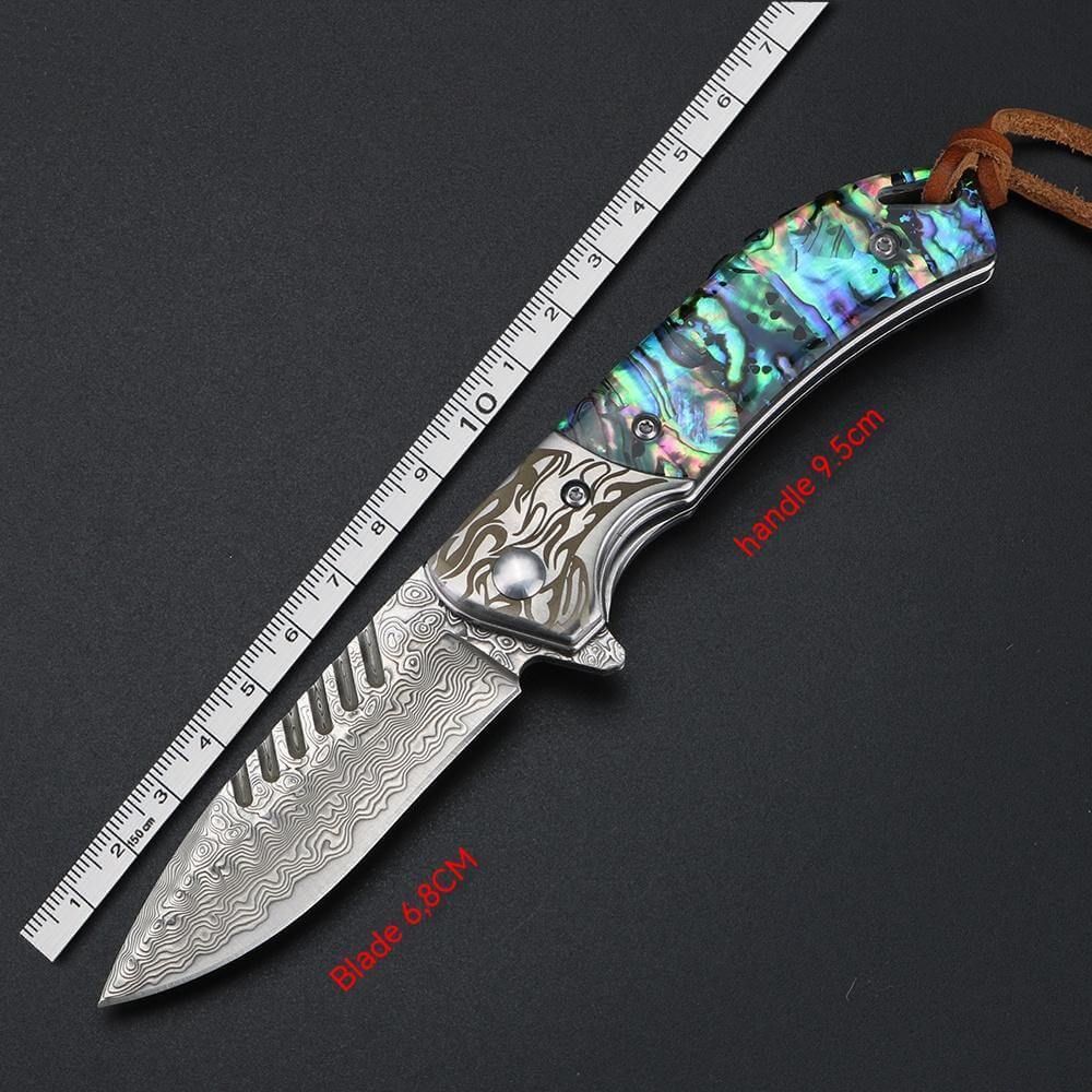 Damascus Steel Folding Knife with 6.8cm Blade and 9cm Handle, Featuring Intricate Patterns and Leather Case, Displayed Next to Ruler