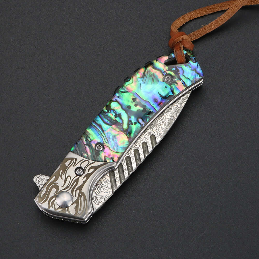 Damascus Sandwich Steel Folding Knife with colorful handle and real leather case, stainless blade, 6.8 cm blade length, resting on black background