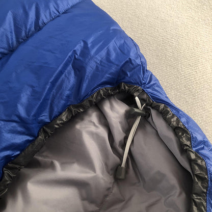 Blue Kamperbox duck down sleeping bag with nylon shell and drawstring closure, perfect for cold weather camping.