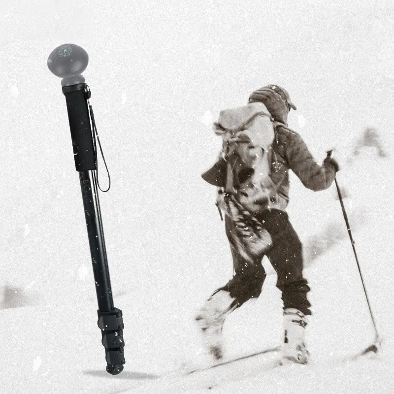 a man in snow with walking cane stick 