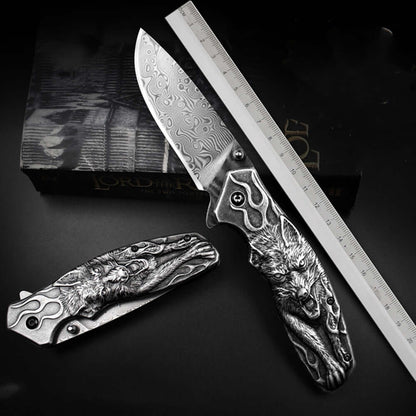 Damascus Steel Folding Knife with Intricate Wolf Handle and Ruler