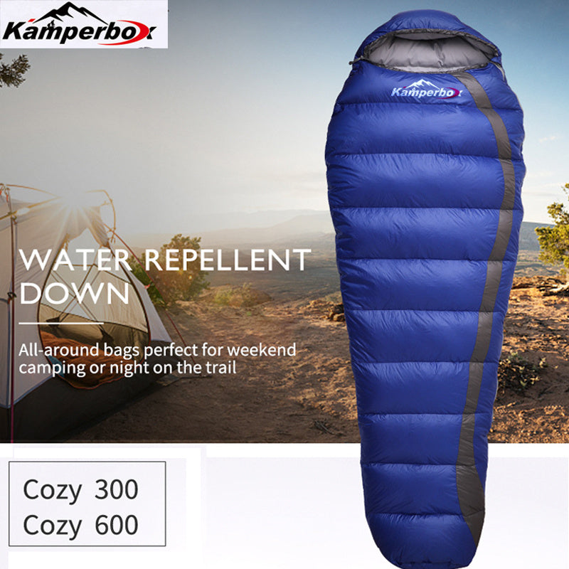 Kamperbox water repellent duck down sleeping bag, ideal for camping, shown with a tent in the background.